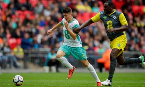Scott Pollock, then of Hashtag United, battles with Emile Heskey at the 2017 Wembley Cup.