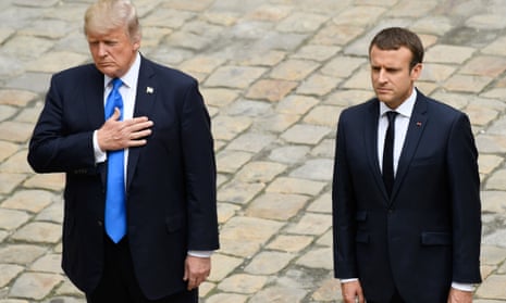 US President Donald Trump and French President Emmanuel Macron stand together during a welcome ceremony at Les Invalides in Paris