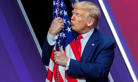 Donald Trump embraces the US flag after speaking to the 47th annual Conservative Political Action Conference.