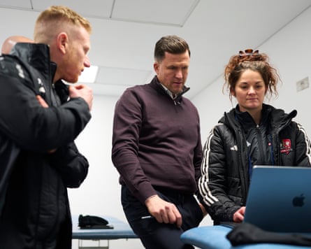 Exeter City manager Gary Caldwell and performance analyst Lauren Jones check out her findings