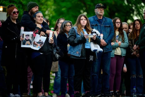people stand at a vigil