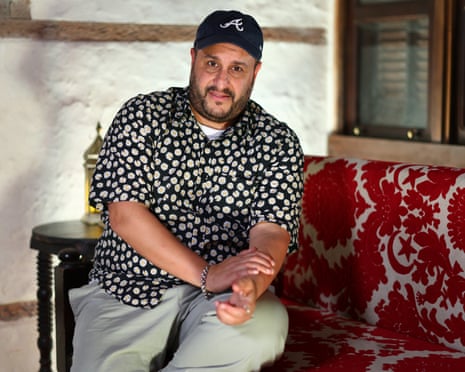 A man sits on a sofa