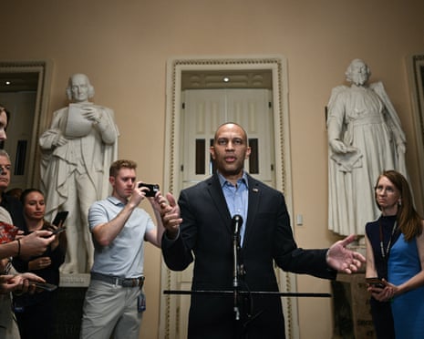person wearing suit speaks to reporters