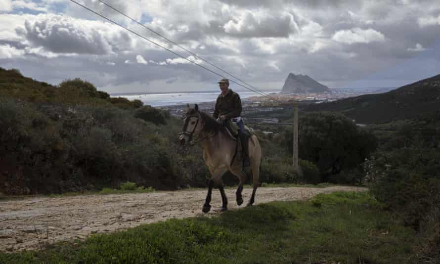 A man on a horse with the Rock and La Línea de la Concepción in the background