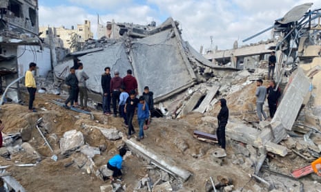 Palestinians check damage at the destroyed al-Sheihk Zakaria mosque in Gaza City after Israeli attacks on Friday.