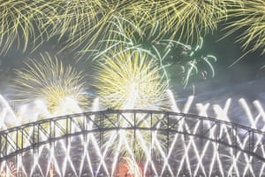 Midnight fireworks explode over the Sydney Harbour Bridge during New Year’s eve celebrations