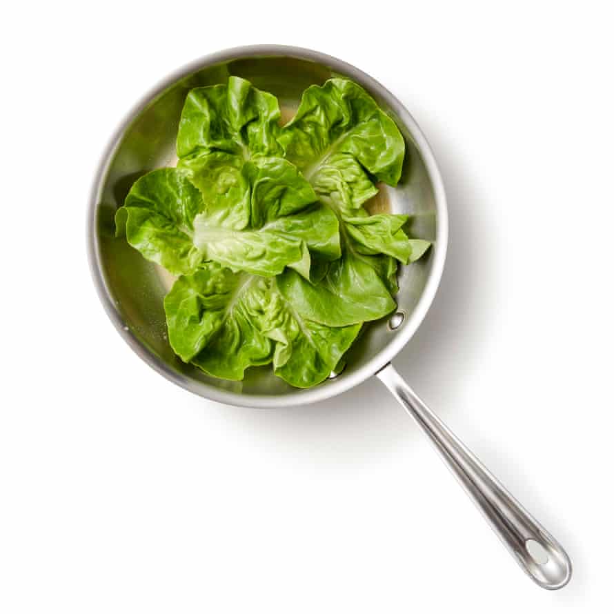 Perfect petit pois a la Francais step 02a. Spread half the butter over the base of a medium saucepan, then use the outer leaves of the lettuce to line the pan.