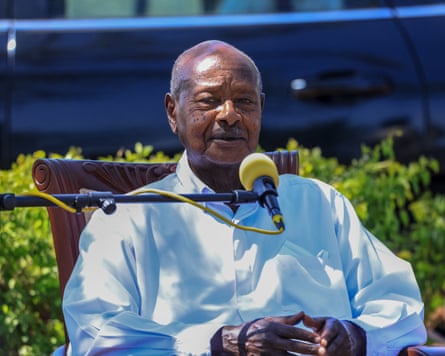 Yoweri Museveni sitting in the sun with a microphone