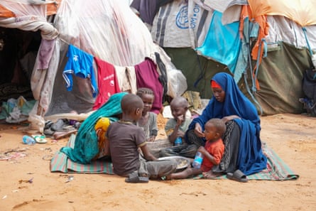 A mother feeding her children at an IDP camp in Kahda district, Mogadishu.