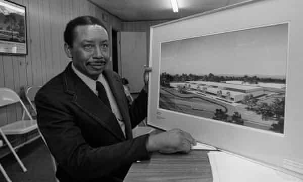 Floyd McKissick poses with an architect’s rendering of the Soultech 1 industrial park.