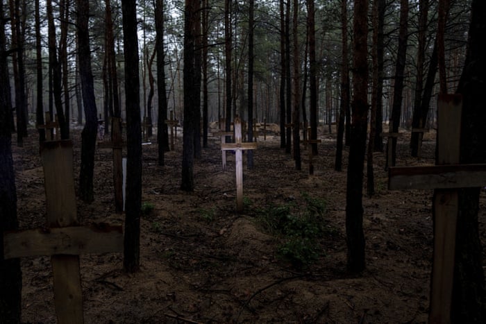 Wooden crosses used as grave markers in a dense forest
