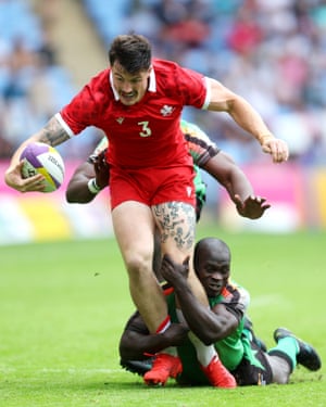 Canada’s Nicholas Allen is tackled by Israel Kalumba and Elisha Bwalya of Zambia during the rugby seven’s pool match