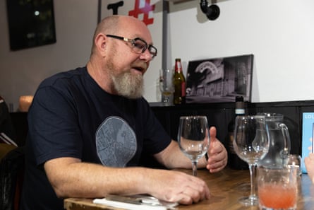 Andy sitting at the table with a glass of wine