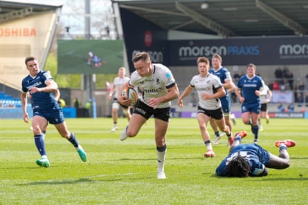 Fergus Burke breaks a tackle to score a try for Saracens against Sale.