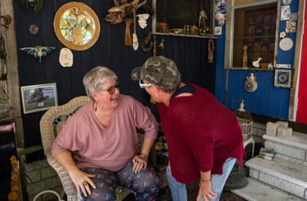 ‘It’s hell’: life under the American mobile home king who calls himself a ‘grave dancer’ Two women laughing together
