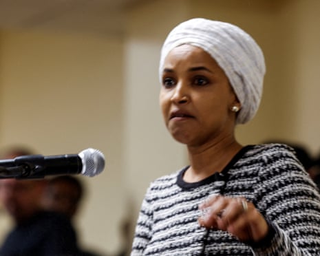 Ilhan Omar reacts as a man (not pictured) disrupts her by spraying an unidentified liquid in her direction during a town hall. 27 January 2026.