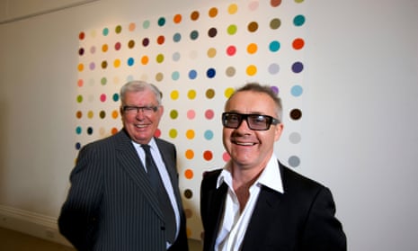 Frank Dunphy with Damien Hirst standing in one of Hirst's multicoloured spot paintings mounted on a white wall