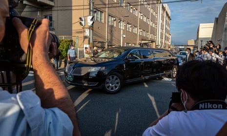 A car believed to be carrying the body of Japan’s former prime minister Shinzo Abe leaves Nara Medical University Hospital.