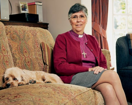 Guli Francis-Dehqani sitting on a sofa alongside a small dog