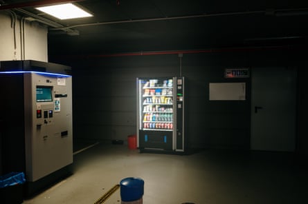 A vending machine casts a glow in a dark car park.