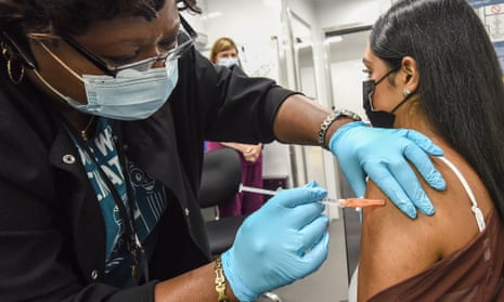 A nurse administers a dose of Covid vaccine to a person at a mobile vaccination event at the Orlando campus of the University of Central Florida and Valencia College.