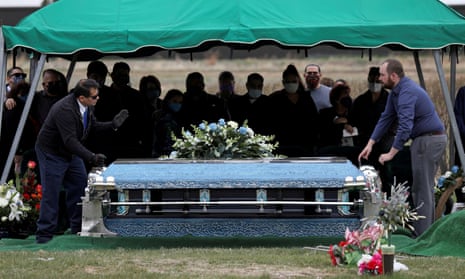The coffin of Saul Sanchez, a meat packing plant employee, is lowered during his funeral after he died of Covid-19 in Greeley, Colorado, in April. The company said it was unclear where he caught the virus.