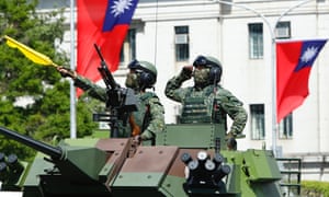 Soldiers riding a tank during Taiwan's National Day celebrations. Photograph: Ceng Shou Yi for
NurPhoto/Rex/Shutterstock
