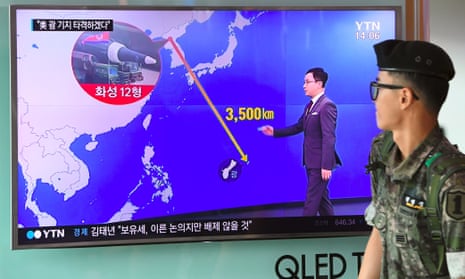 A news bulletin shows the distance between North Korea and Guam at a railway station in Seoul. 