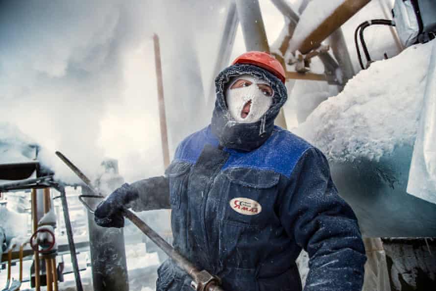 A gas worker in Russia’s sub-Arctic Ural region sprays steam on gas condensate pipelines to prevent them from freezing in -42C outdoor temperature