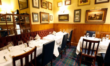 Half-panelled walls, tableclothed tables and a velvet-covered banquette