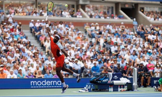 Frances Tiafoe hits a high-reaching no-look return during his victory over Rafael Nadal at the Arthur Ashe Stadium