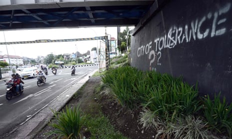 Motorists in Yogyakarta pass by graffiti calling for tolerance amid an increase in verbal attacks on the LGBT community.