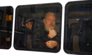 Julian Assange is seen in a police van after was arrested by British police outside the Ecuadorian embassy in London