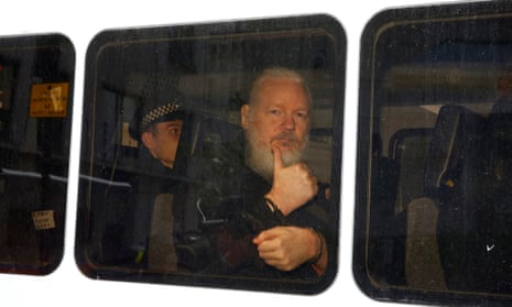 Julian Assange is seen in a police van after was arrested by British police outside the Ecuadorian embassy in London