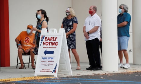 People line up at a polling station as early voting begins in Pinellas county ahead of the election in Largo, Florida, 21 October 2020.