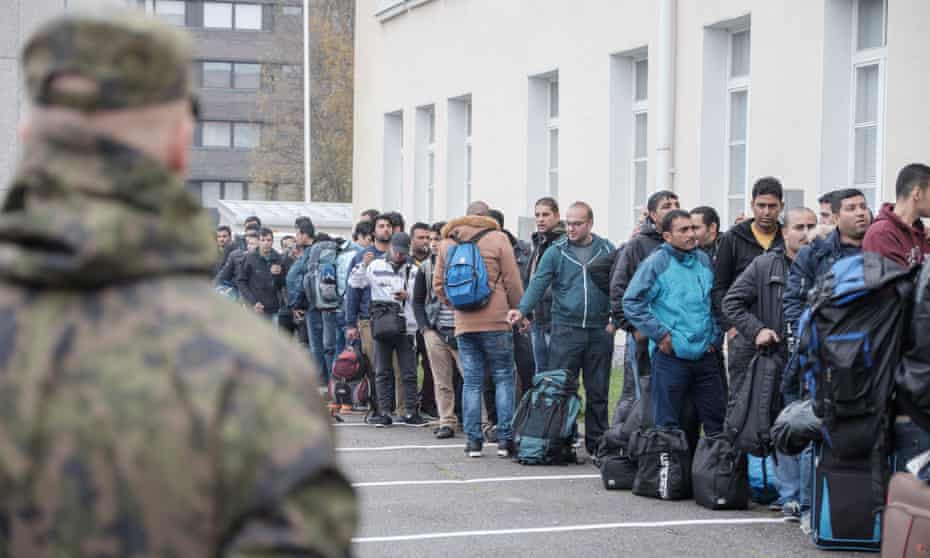 Asylum seekers queue at a refugee reception centre in the town of Tornio, northern Finland, in September 2015