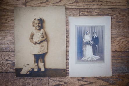 Photo of two old sepia photos on a wooden table