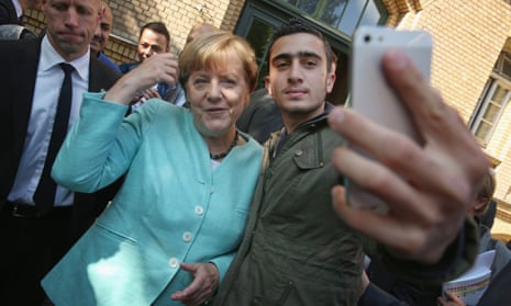 Anas Modamani takes a selfie with Angela Merkel in Berlin in September 2015