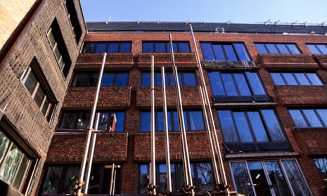 Photo of a nearly complete refurbished office building with a red brick facade