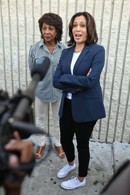 Kamala Harris speaks to the media accompanied by Congresswoman Maxine Waters at a Labor Day rally for healthcare workers last September.