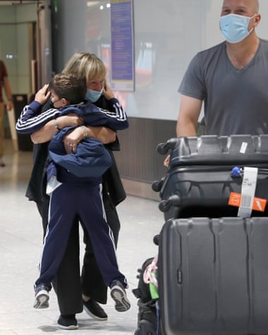 Sue Blake embraces her grandson at Heathrow.
