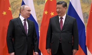 The Chinese president, Xi Jinping, right, and the Russian president, Vladimir Putin, talk to each other during their meeting in Beijing on 4 February.