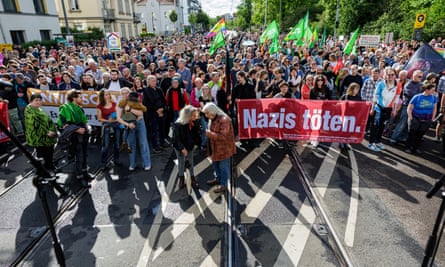 People hold a banner that reads ’Nazis kill’ as they protest against recent violence against politicians and election campaign volunteers in Dresden.