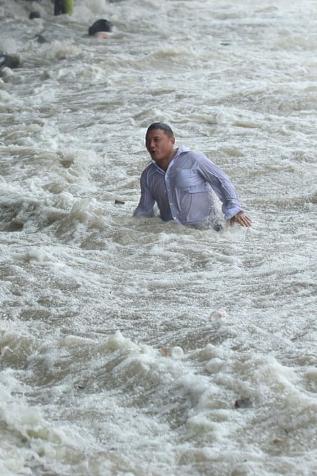 A man by the Qiantang river after Typhoon Dujuan hit China. Claims for flood damage could affect financial stability. 