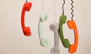 Telephone handsets dangling in a row