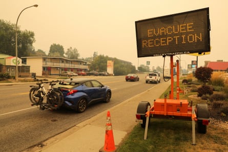 A sign directs motorists to a location for people evacuating from wildfires in Vernon, British Columbia