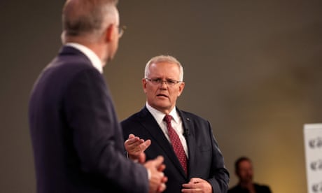 Australian Prime Minister Scott Morrison speaks as Australian opposition leader Anthony Albanese looks on during the first leaders' debate of the 2022 federal election