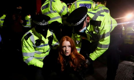 Police detain a woman at a protest at Clapham Common after the murder of Sarah Everard, March 2021.
