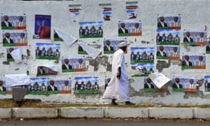 A Comoran man walks past campaign posters on his way to vote during the presidential elections on December 26, 2010 in the capital Moroni. The Indian Ocean archipelago of Comoros voted today to elect a new president to replace incumbent Ahmed Abdallah Sambi whose extended stay in power has threatened the stability of the coup-prone islands. AFP PHOTO / SIMON MAINA (Photo credit should read SIMON MAINA/AFP/Getty Images)