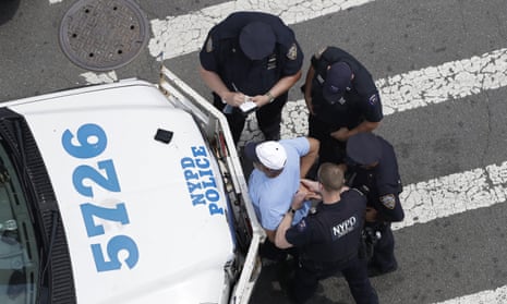 New York City police officers detain and question a man in the Bronx.